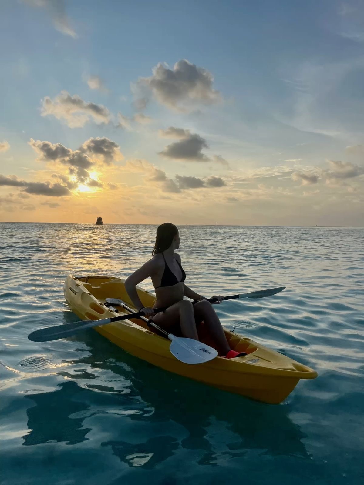 Aerial view of a jet ski speeding over blue ocean water